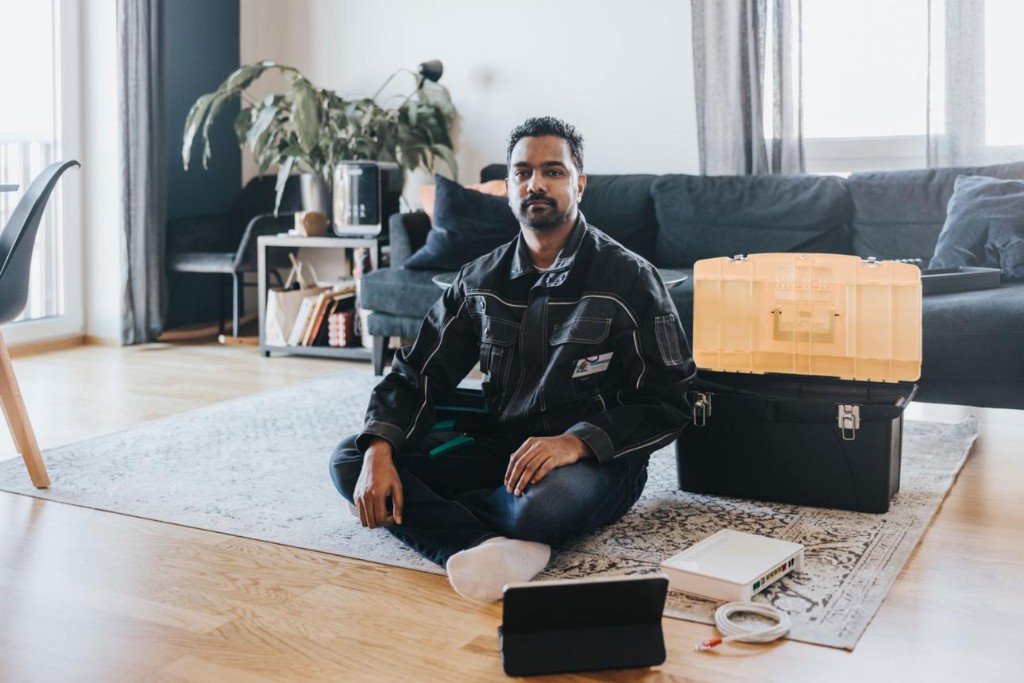 Technician installing fiber broadband in a customer home